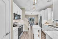 Quartz counters with gold veining, gold fixtures, gorgeous backsplash