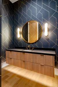 The elegant main powder room  serves as a stylish statement space in this home.
