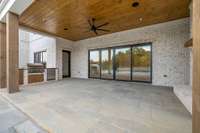 Unwind in this inviting basement-level covered living area, complete with a cozy fireplace, grilling station, all while enjoying picturesque views of the pool and spa - your perfect private retreat for year-round relaxation and entertaining.