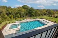 Discover the ultimate luxury with this elevated view of the pool and spa, adorned with stunning linear fire bowls
