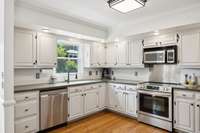 The kitchen features classic white cabinets and canned lighting for a bright, inviting atmosphere.2648 Chatham Ct Murfreesboro, TN 37129
