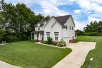 Large concrete driveway makes coming and going easy- plenty of parking area