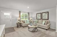The spacious living room with visible sightlines to the kitchen.