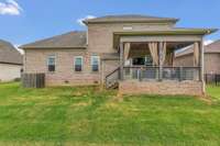 The back of the home has a private covered modern deck.