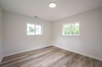 Fresh paint, new LVP flooring, new sub-flooring, new windows and light fixtures shown here!