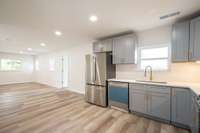 New cabinets, quartz counter tops, GE Stainless Steel Refrigerator, Range, Dishwasher, and Microwave.  New LVP flooring, paint, and fixtures!