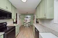 Beautiful Galley Kitchen (Farm Sink) & Breakfast Nook with built in Table & granite countertops.