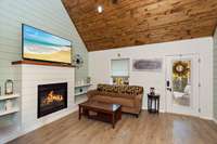 Family room with fireplace that goes to outdoor space. Enjoy your TV time or cozy up by the fireplace.