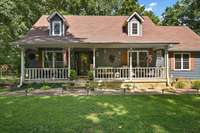 Enjoy relaxing on the inviting, rocking-chair front porch of this charming home, which features a freshly painted exterior for enhanced curb appeal. The property also includes a detached garage that has been recently painted to match.