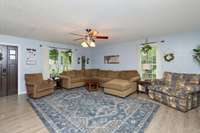 Living room is spacious and flows into kitchen and Family room. Beautiful updates throughout home, including LVP floorings and paint.