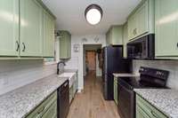 Beautiful Galley Kitchen (Farm Sink) & Breakfast Nook with built in Table & granite countertops. Leads into sitting area and Laundry Room before heading to the attached garage!