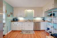 This charming, roomy kitchen is very inviting and makes you want to bake.