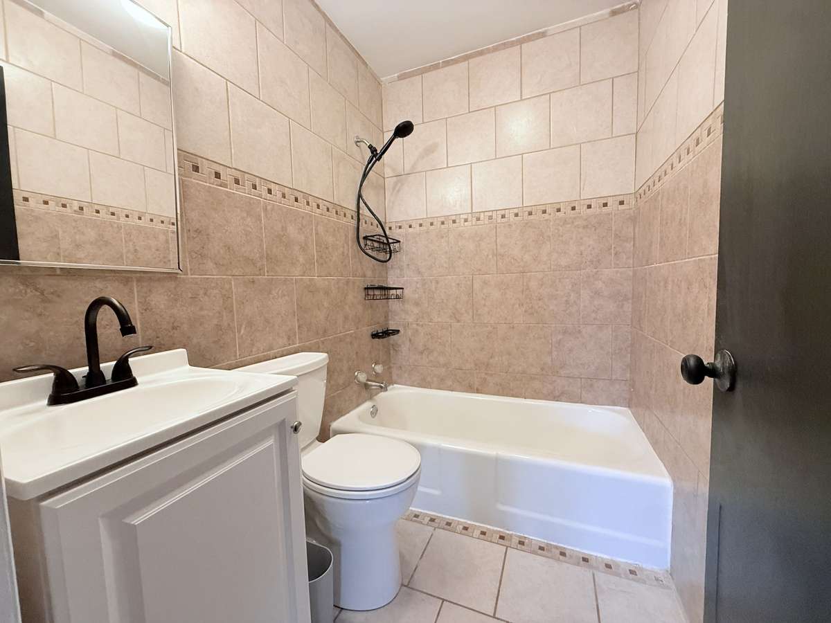 The bathroom has tile throughout