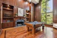 Opulent billiards room with original herringbone wood floors and cabinetry contrast the updated modern interior of this home beautifully.
