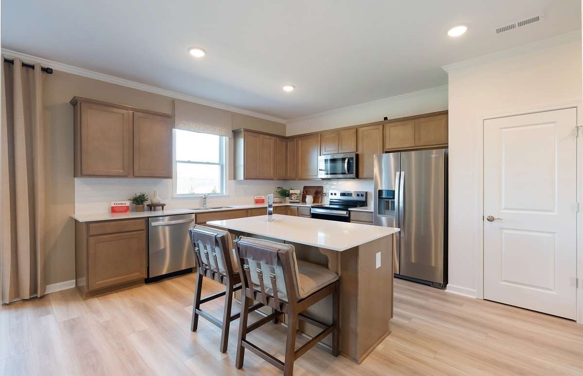 ***Photo is from a brand new Rosella home*** The Kitchen is the heart of the home, and this one will not disappoint. We have included gray cabinetry, white quartz countertops, and a white subway tile backsplash.