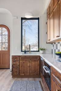 Large windows invite natural light while the open floor plan creates a welcoming atmosphere within the space.