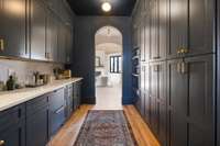 A dedicated butler pantry nearby for overflow food storage, meal preparation, and extra cleanup capacity during large gatherings and special events.