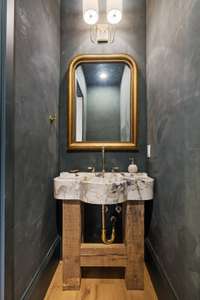 A half-bath with Venetian plaster finishes and an imported custom marble sink.