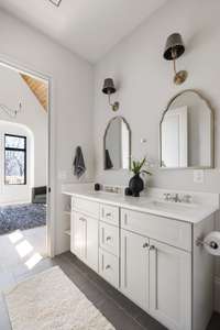 The apartment also features a full bath and double vanity sinks located just off the bedroom.