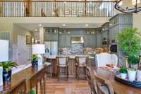 View of kitchen and dining with optional finished loft above.