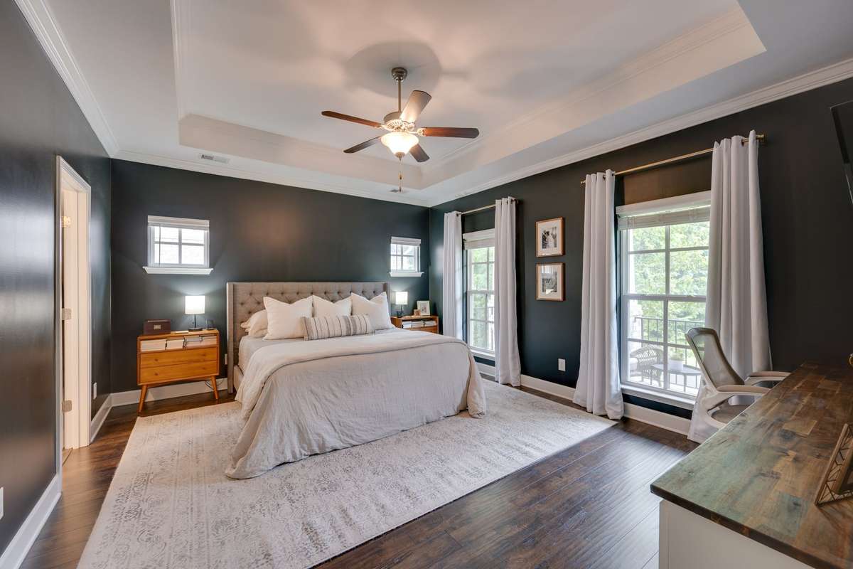 Spacious primary bedroom shown here with a king size bed
