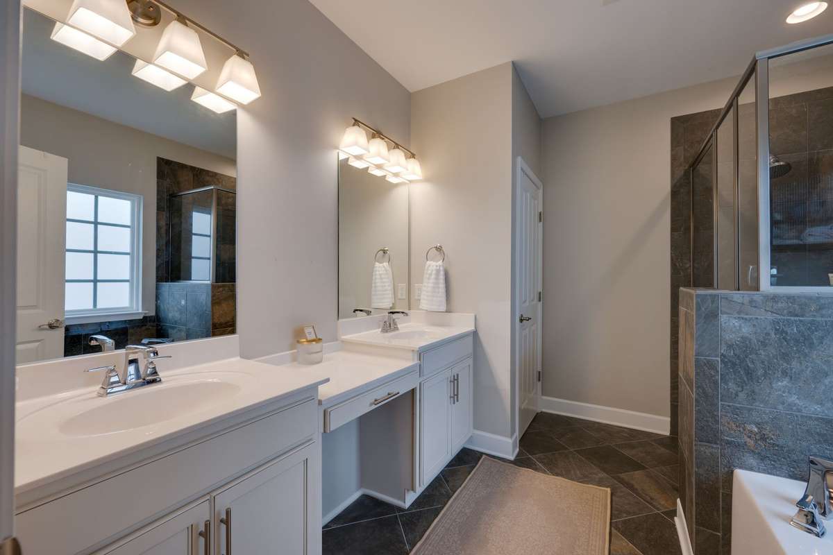 primary bathroom with a separate tub and shower
