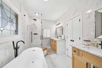 Separate his-and-hers sinks with sleek countertops and custom cabinetry.