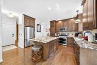 Spacious kitchen with granite countertops and a large island making it perfect for hosting big parties.