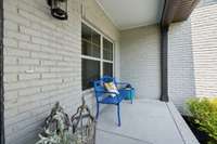 Decorate this adorable front porch to your heart's content. What a perfect spot to enjoy your morning coffee!
