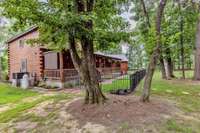 The sideview of the home.  This yard is great.  Lot's of trees to provide privacy and shade.