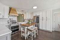 Spacious kitchen has been completely renovated.  New cabinetry, all new appliances, new bay window and lots of prep space!