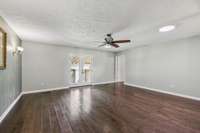 Extra large family room with engineered hardwood and fresh paint and fixtures.
