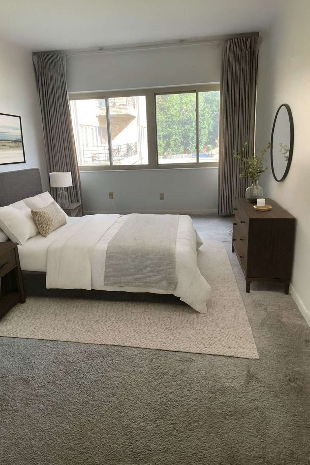 Large primary bedroom with 2 closets and en suite bathroom. The furnishings are virtually shown.