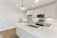 Walk-in pantry has plenty of shelving, an excellent compliment to the ample cabinets and shelves in the kitchen.