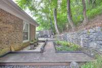 The private backyard offers a peaceful, natural escape with mature trees that provide shade, beauty, and a sense of seclusion.