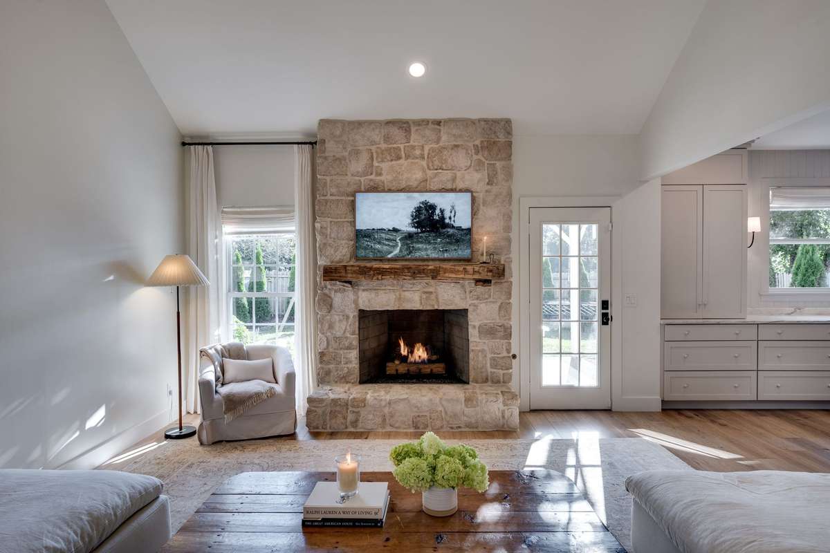 Stunning stone fireplace with tons of natural light in this space!
