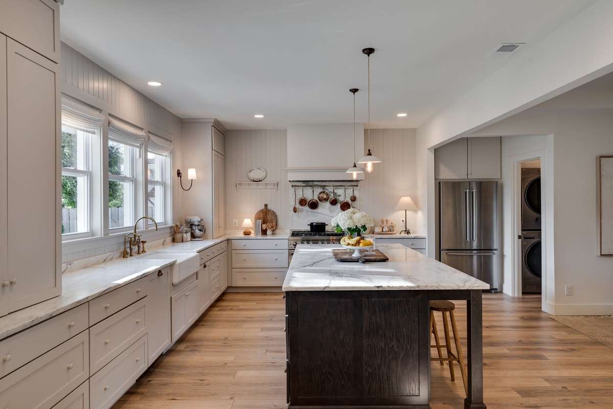 Custom marble countertops and reverse osmosis water filter with DeVol Kitchens brass faucet