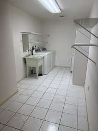 Huge laundry room with washer, dryer and sink