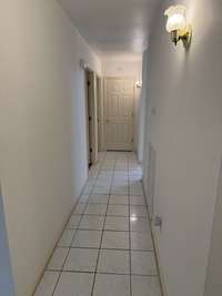 hall way leading to three bedrooms