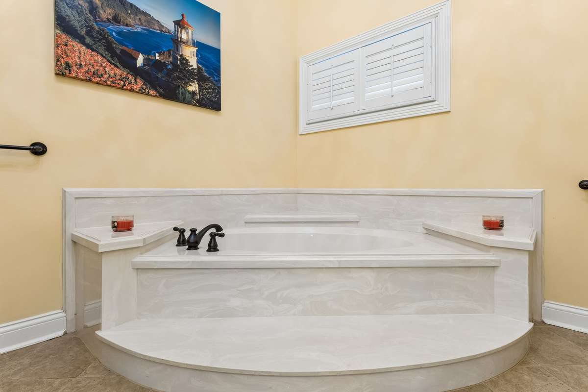 Primary bath also features a marble soaking tub with rubbed bronze fixtures and window with plantation shutter. 2230 Northwoods Drive, Murfreesboro, Tn 37130