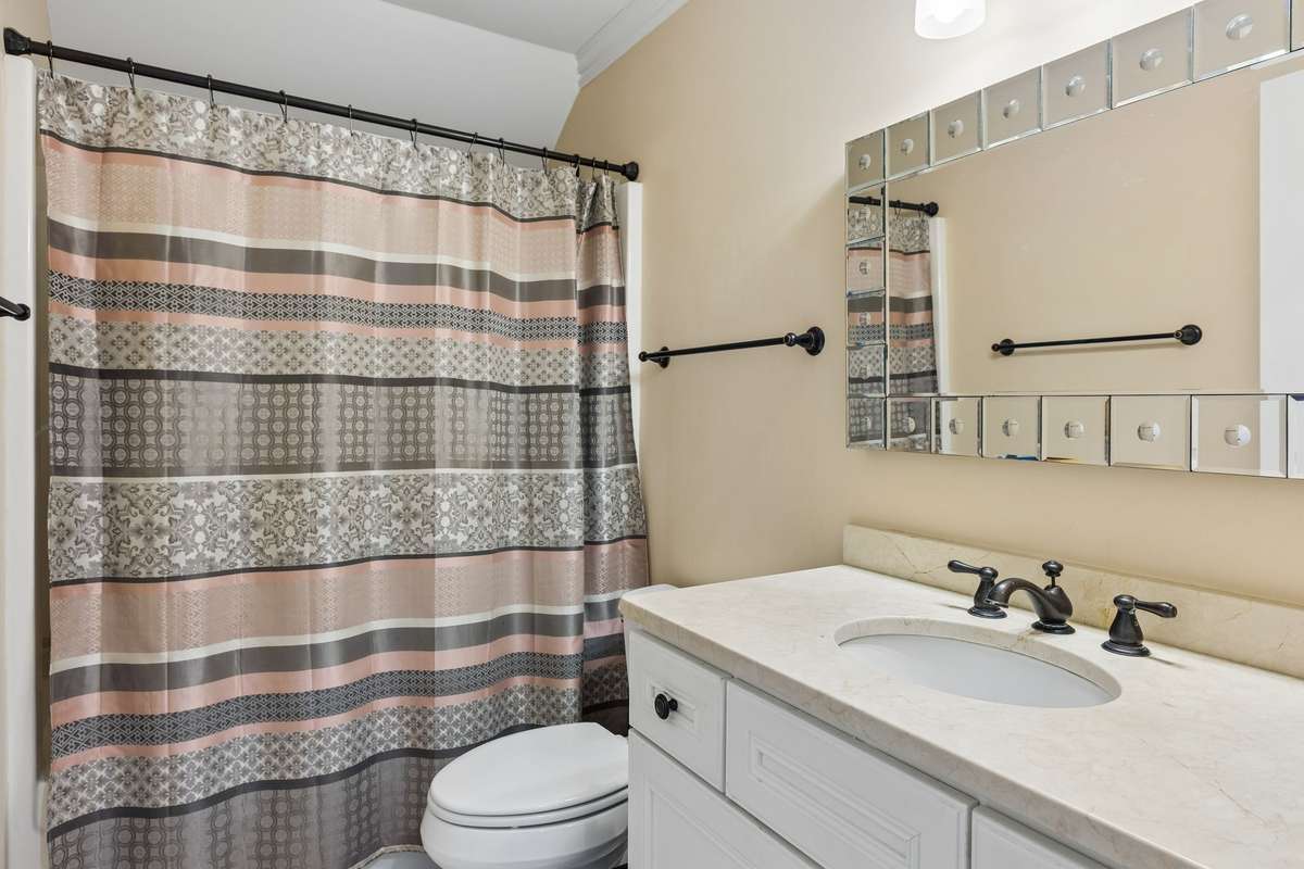 Guest bathroom with a single vanity, combo tub & shower, & tiled floor. 2230 Northwoods Drive, Murfreesboro, Tn 37130