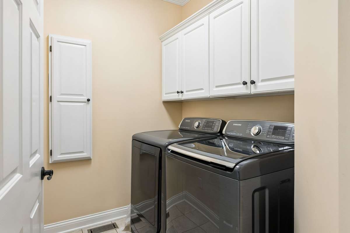Spacious laundry room with cabinetry, tiled floor, and built-in iron board! 2230 Northwoods Drive, Murfreesboro, Tn 37130