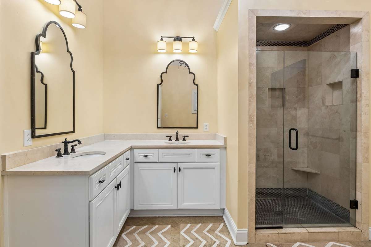 Primary bath features double vanities, tiled walk in shower with glass door. 2230 Northwoods Drive, Murfreesboro, Tn 37130
