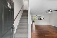 Step inside to durable LVP flooring throughout the main level and brand-new Berber carpet upstairs. The open layout connects the living area to the kitchen and dining space, with plenty of natural light and functional flow.