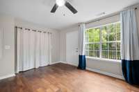 Big window, peaceful view, and direct access to the back deck—this spot off the kitchen is ideal for a dining table or flex space. Ceiling fan keeps the air moving. Clean, bright, and functional.