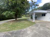 Another view of that great side patio and the gorgeous Magnolia. In the distance you can see just how long that driveway is.