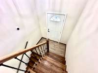 Welcoming entry landing with immediate access to both upper and lower levels—designed for easy flow and functionality in this classic split-level layout.