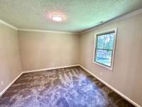 The back half of the primary bedroom offers incredible flexibility with room to grow—whether you envision a luxurious full bath, expanded closet space, a cozy sitting or reading area, or even an adjoining nursery!