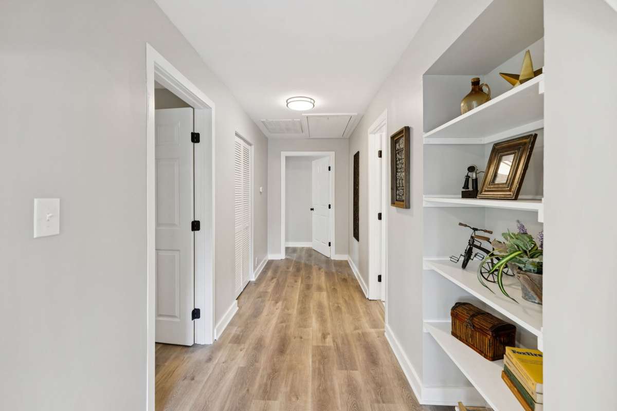 This hallway features nice built in shelves and a laundry closet on the main level (there are additional laundry connections in the garage in the Basement