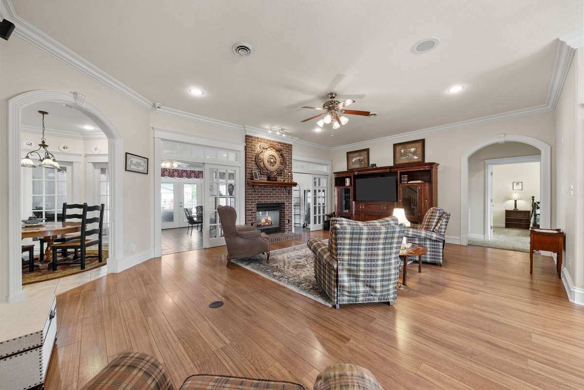 Huge, open living room with a double-sided fireplace that is open to the kitchen, formal dining room, and sunroom.  This is a great area for family get-togethers and holidays.